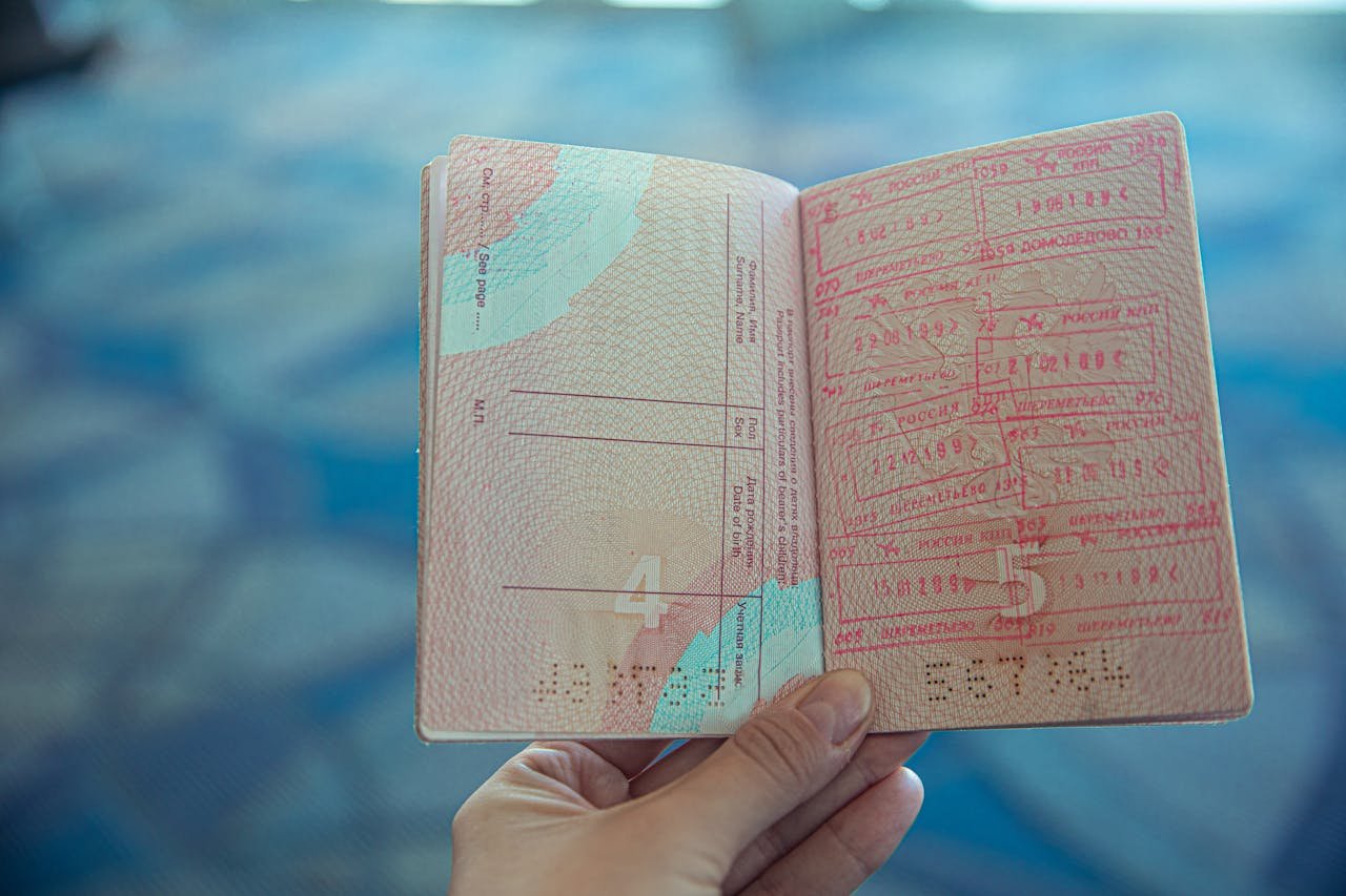 Photo by Ekaterina Belinskaya: https://www.pexels.com/photo/person-holding-an-opened-passport-4922356/