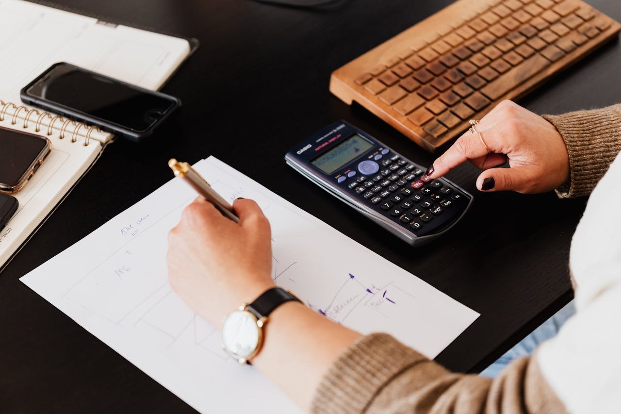 Photo by Karola G: https://www.pexels.com/photo/bookkeeper-writing-down-on-paper-while-using-calculator-4476375/